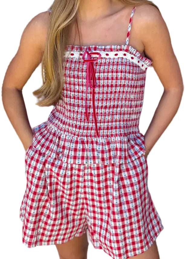 Woman wearing a red and white checkered dress in a store setting