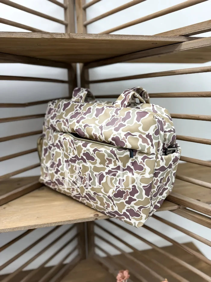 Camouflage-patterned bag on a wooden shelf