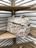 Camouflage-patterned bag on a wooden shelf