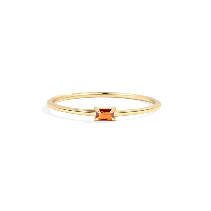 Gold ring with a square-cut orange gemstone on a white background