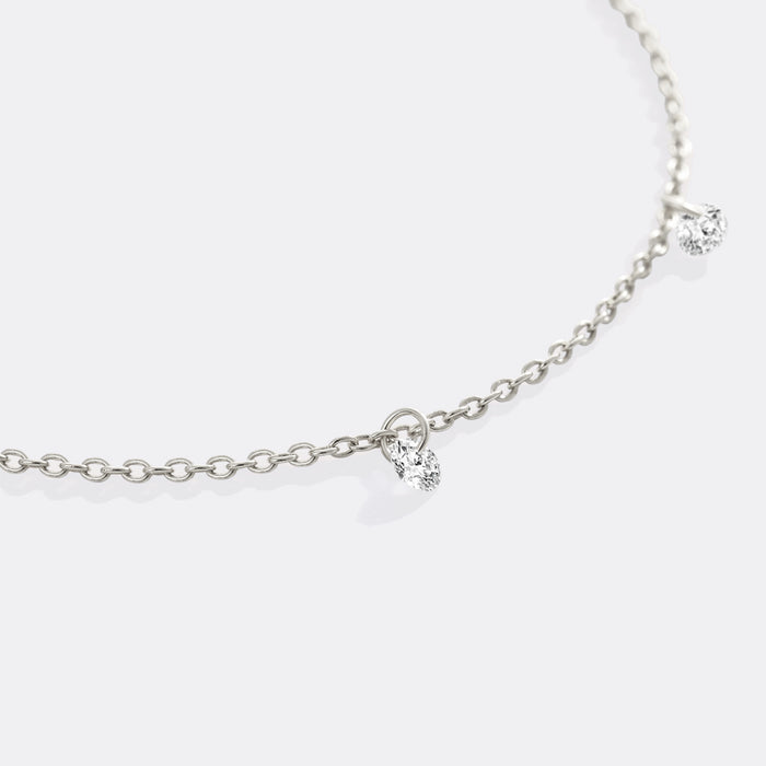 Silver necklace with a small heart pendant on a white background