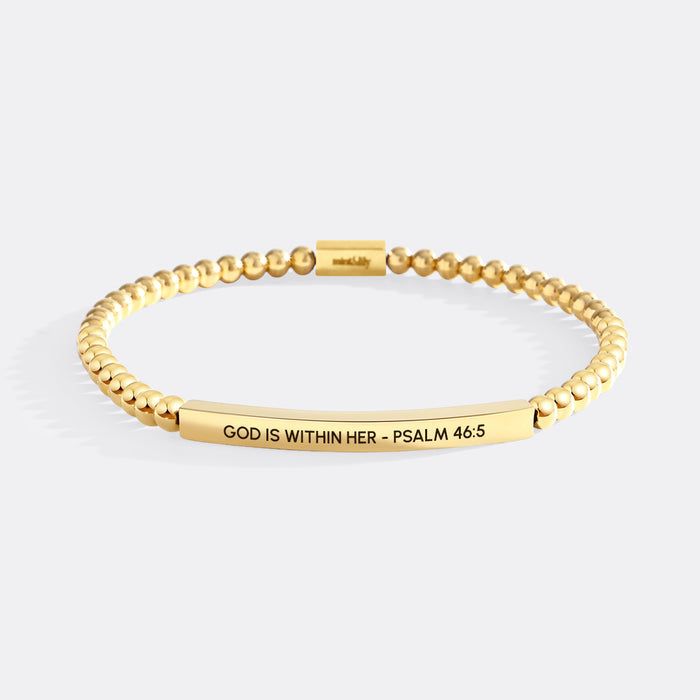 Gold bracelet with engraved text on a white background