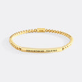 Gold bracelet with engraved text on a white background