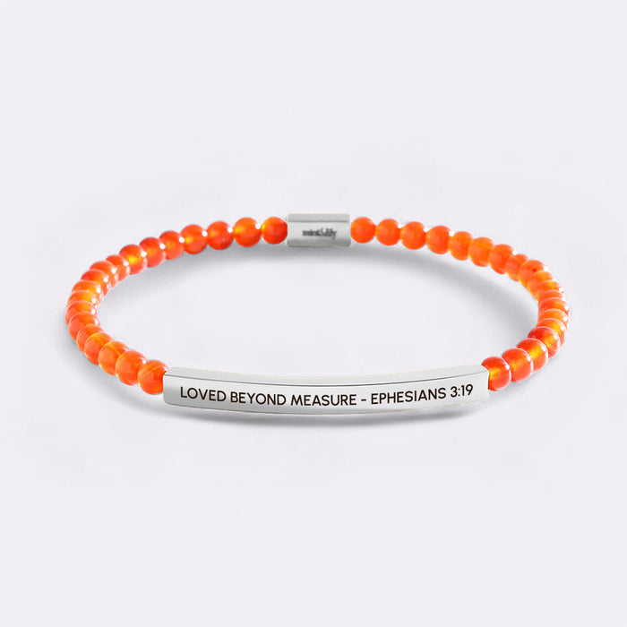 Orange beaded bracelet with silver bar and text on a white background