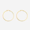 A pair of large gold hoop earrings on a black background, showcasing their shiny and polished surface.