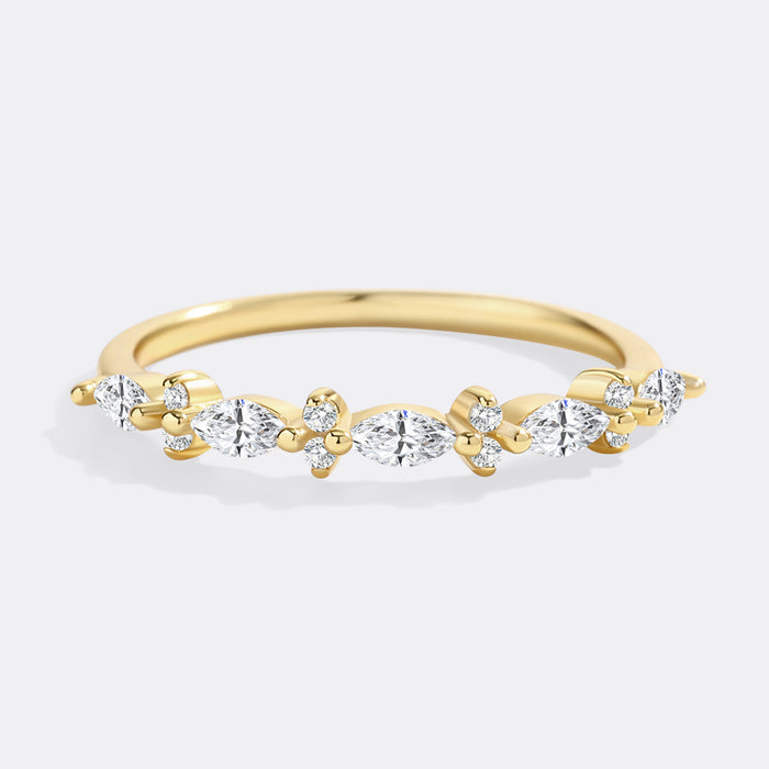 Gold ring with diamonds on a light gray background