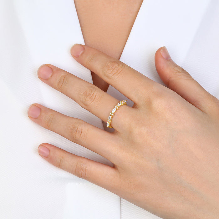 Hand wearing a gold ring on a white background
