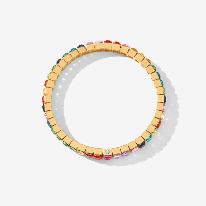 Gold bracelet with colorful gemstones on a white background