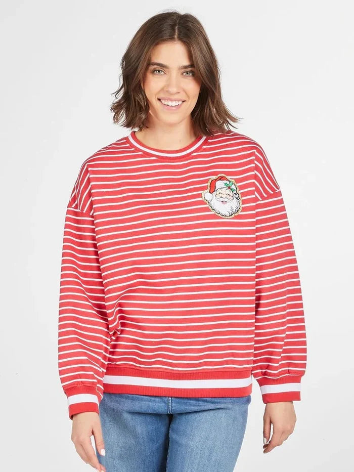 Person wearing a red and white striped sweater with a graphic design on a plain background