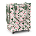A rolling storage cart with a pink and green floral pattern, featuring olive green handles and a small 'swag' brand logo on the front, set against a plain white background.