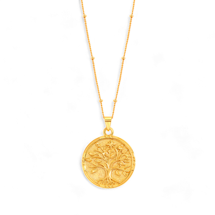 A gold vermeil coin pendant necklace with an embossed Tree of Life design on the pendant, displayed on a satellite chain against a black background.